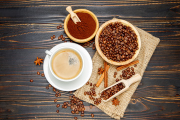 mug with roasted coffee beans on wooden background