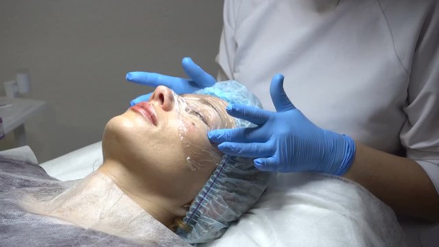 Young woman getting treatment in beauty saloon