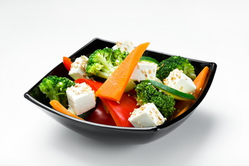 Healthy fresh salad with feta cheese and vegetables isolated