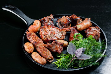 Roasted and grilled various meat with potatoes in a pan