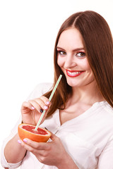 Woman holds grapefruit drinking juice from fruit