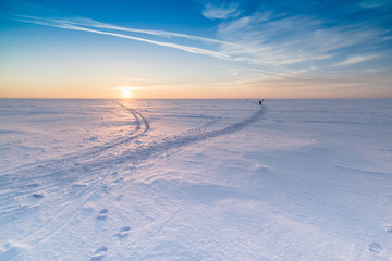 Winter landscape with the setting sun