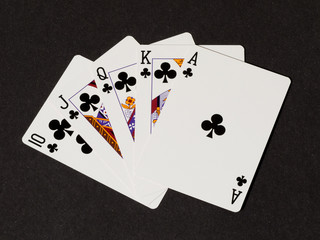 Royal flush of clovers on black canvas