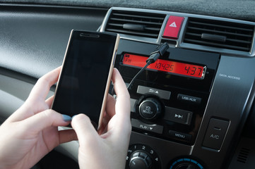 Hand hold smartphone in car,People press the phone while driving