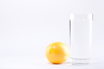 glass of water with lemon on a white background