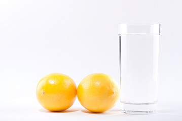 glass of water with lemon on a white background