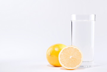 glass of water with lemon on a white background