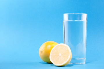 glass of water with lemon on a blue background