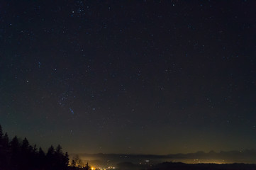 Naklejka na ściany i meble Stars at night, Swiss Alps in horizon
