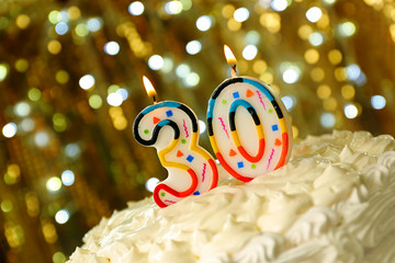 Birthday cake with candles on bokeh background