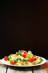 Delicious pasta on plate on grey wooden background