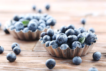 Ripe and tasty blueberries on brown wooden table