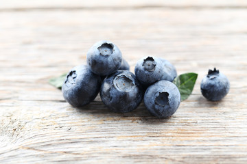 Ripe and tasty blueberries on grey wooden table