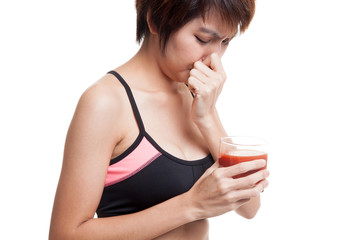 Beautiful healthy Asian girl hate  tomato juice.
