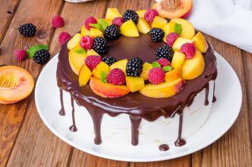 Vanilla mousse cake with peaches and chocolate glaze