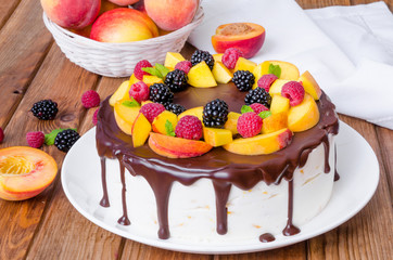 Obraz na płótnie Canvas Vanilla mousse cake with peaches and chocolate glaze