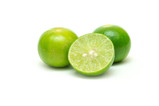 Limes and a half cut with seeds inside on isolated white background.