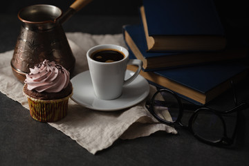 Obraz na płótnie Canvas Chocolate cupcakes and coffee on dark background. Photo in a dar