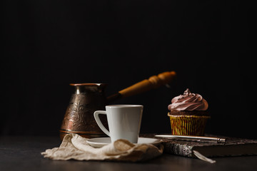 Coffee cup and cupcake whit chocolate and cream on stone