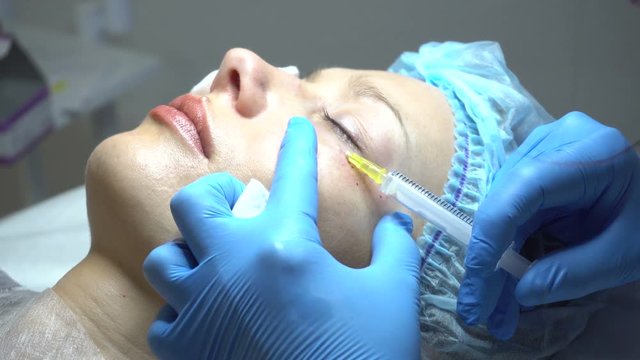Young woman getting treatment in beauty saloon