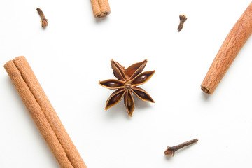 Set of cinnamon, clove and star anise, scattered in a chaotic manner, isolated on white background