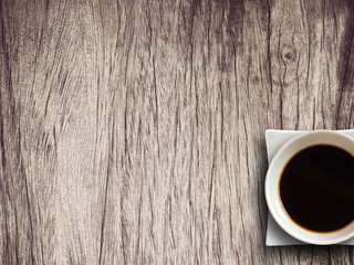 Coffee cup on wooden table background textured.