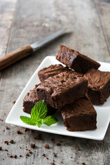 Chocolate brownie pieces on wooden background
