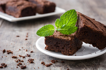 Chocolate brownie pieces on wooden background
