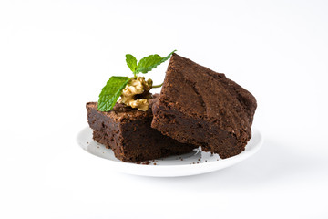 Chocolate brownie pieces isolated on white background
