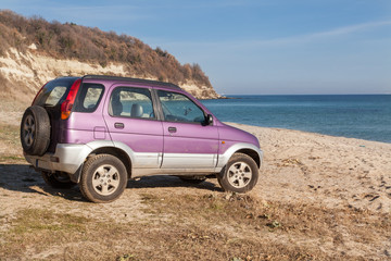 4wd car, SUV on the wild beach. Vacation, adventure concept.