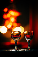 two wine glasses and defocused lights at the restaurant