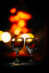 two wine glasses and defocused lights at the restaurant