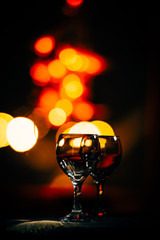 Fototapeta na wymiar two wine glasses and defocused lights at the restaurant
