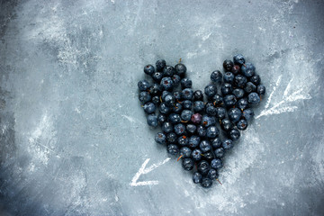 Heart of berries , blue heart of blueberry , love and health concept