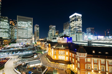 Fototapeta na wymiar Asia Business concept for real estate and corporate construction - panoramic modern cityscape building bird eye aerial night view of Tokyo Station under neon light and dark blue sky in Tokyo, Japan