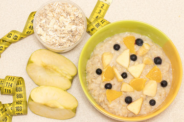 Morning healthy nutrition, diet frame with oatmeal porridge, fru