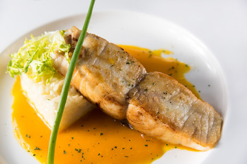 Grilled cod with green asparagus, green salad, lemon Pumpkin Cream Sauce