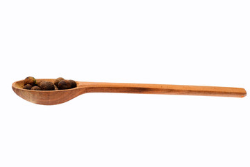 spicy allspice in wooden spoon