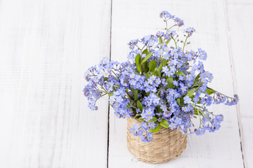 blue flowers bouquet on white wooden background