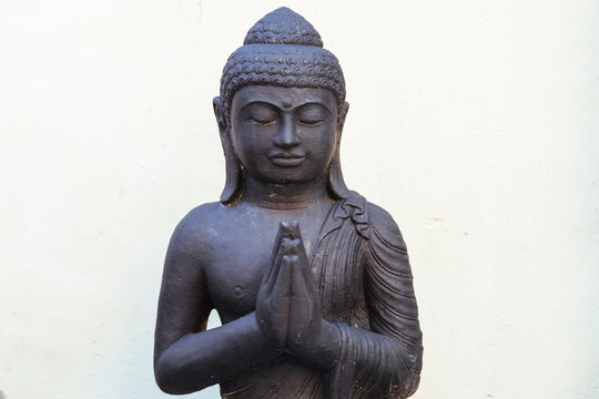 Sculpture Of Buddha Made In Black Stone With White Background