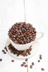 coffee beans cup on white wooden background