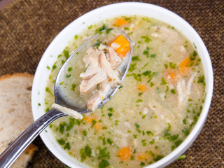 traditional barley soup with meat in a white bowl
