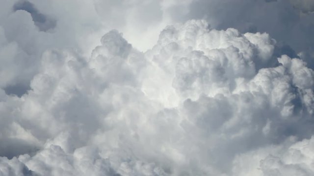 Close up large clouds seen from air that slowly pass from right to left. Aerial shot. Top view.