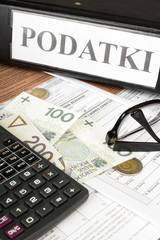 Filling in polish individual income tax form PIT with money and pen