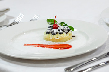 dessert, blueberry and cherry on a plate.
