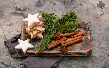 Christmas cinnamon star cookies on wooden board and.