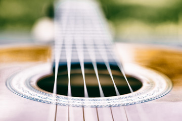 Acoustic guitar bridge and strings close up - macro - very shallow depth of field - vintage version