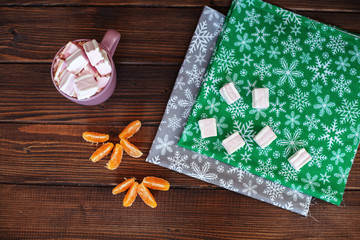 wooden background with coffee, tangerines and Marshmallow.
