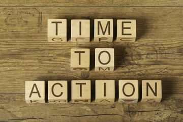 time to action text on wooden cubes on a wooden background