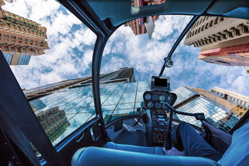 Helicopter cockpit flying on Sky Blue Glass High-rise Facade. Panoramic wide angle view. Causeway Bay, Hong Kong Island.